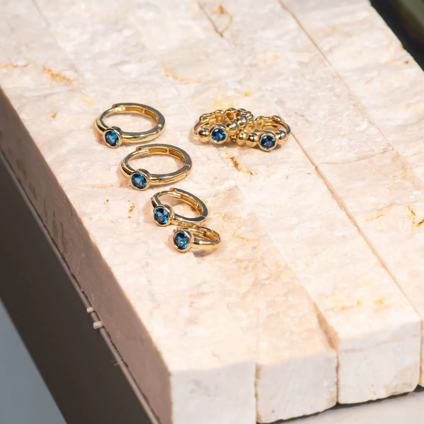 Bezel Set Blue Topaz Huggie in 14k Gold